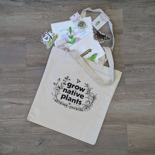 The "Grow Native Plants" tote bag with a selection of gardening and pollinator stickers, buttons, and screen prints
