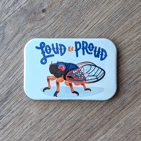 A cicada refrigerator magnet with the words loud and proud.
