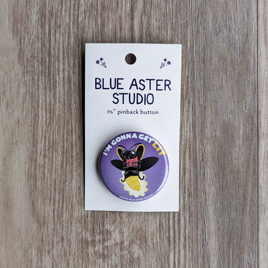 A round one and a half inch pinback button featuring an illustrated firefly glowing with the text "I'm gonna get lit."