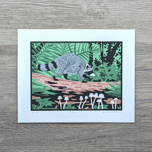 A screen print of an illustration of a raccoon walking along a fallen log surrounded by ferns, mushrooms, moss, and shrubby plants.
