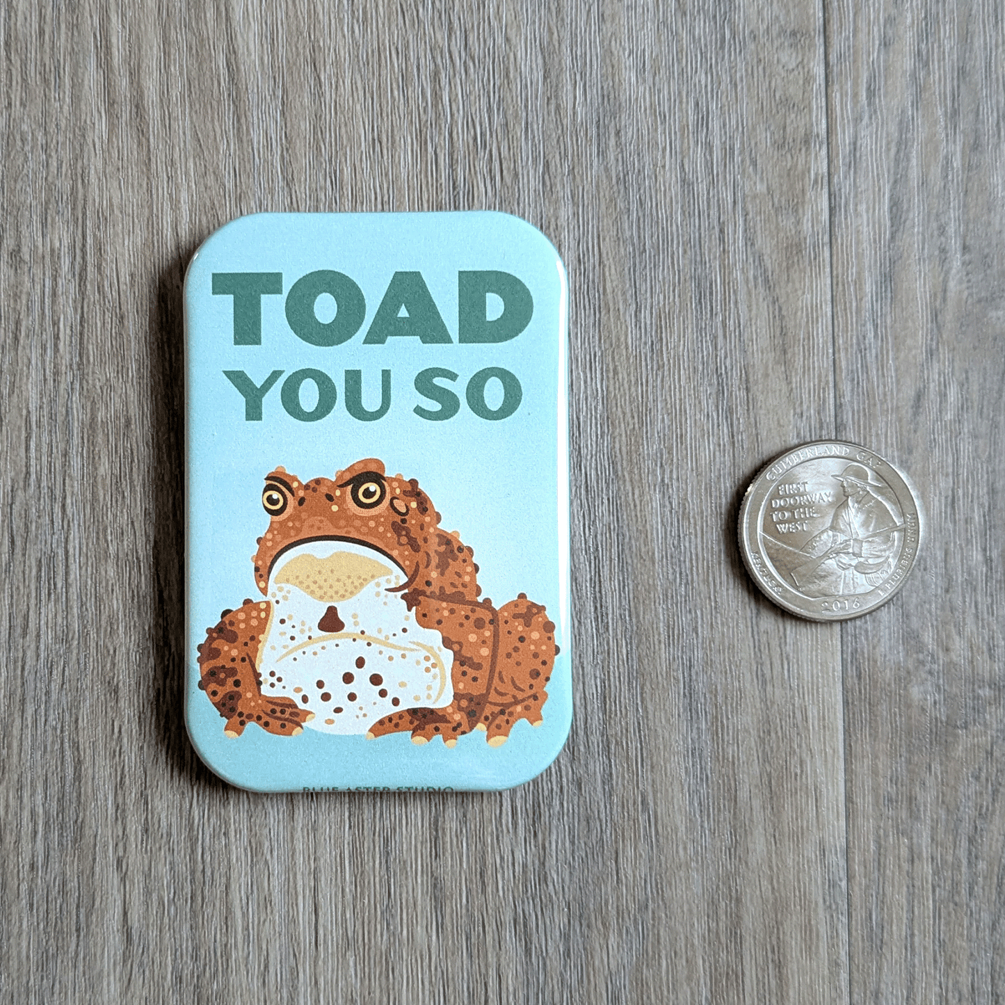 The Toad magnet with an american quarter coin for scale.