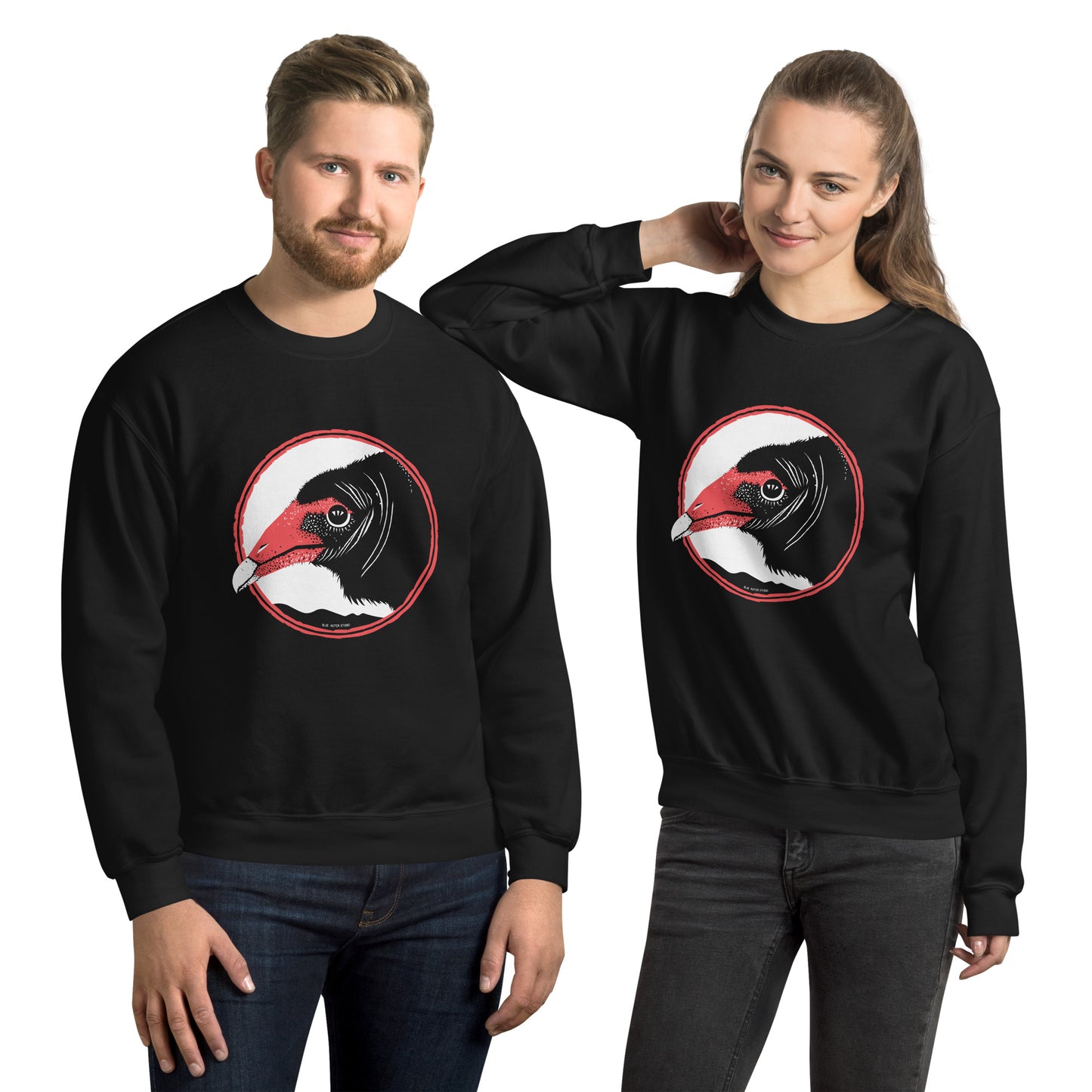 A man and a woman hanging out in matching turkey vulture sweatshirts.