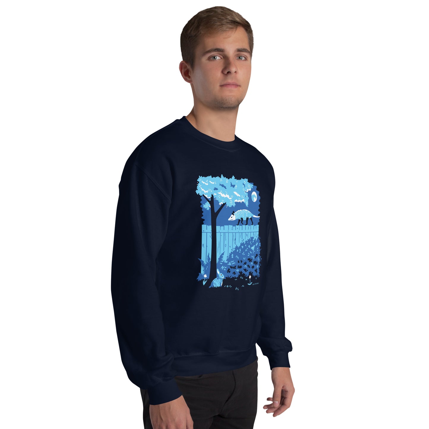 A model wearing the illustrated opossum and bunny night time backyard sweatshirt in navy blue.