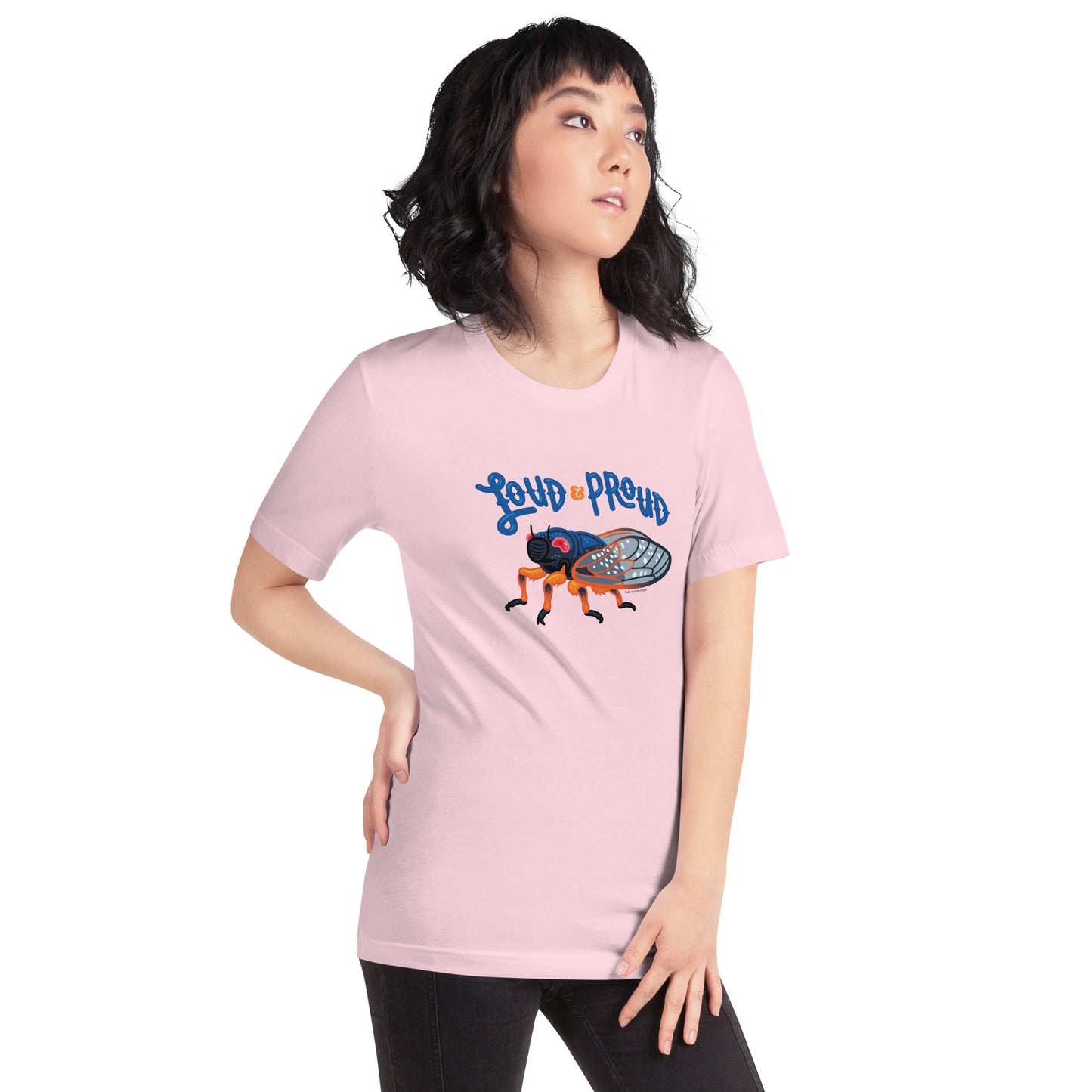 A woman showing off the cicada short-sleeved t-shirt in the soft pink color.