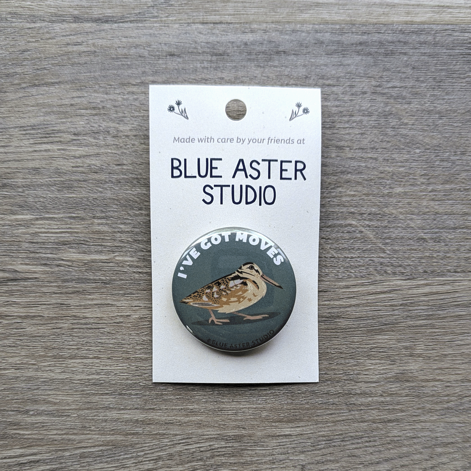 A 1.5 inch pinback button featuring an illustration of a woodcock with the words "I've Got Moves" above it.