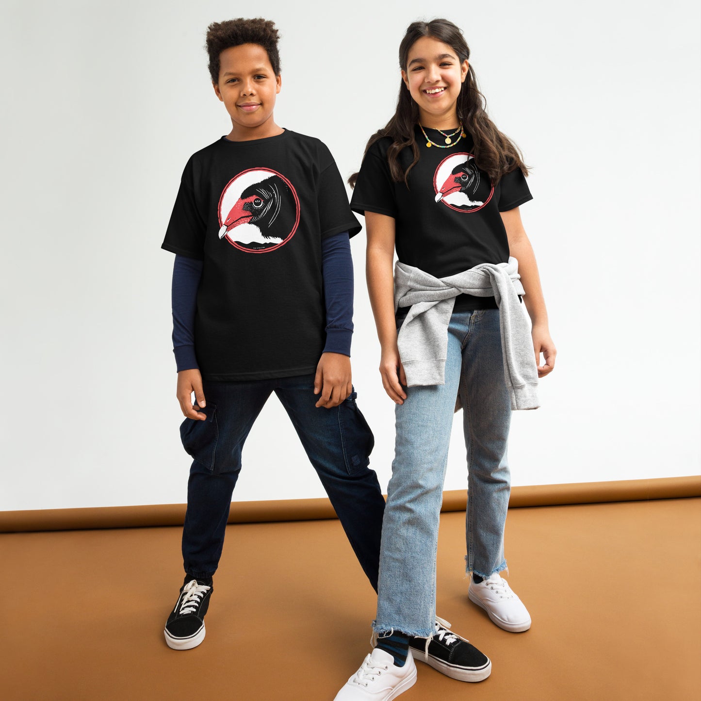 A boy and girl wearing Blue Aster Studio turkey vulture t-shirts.