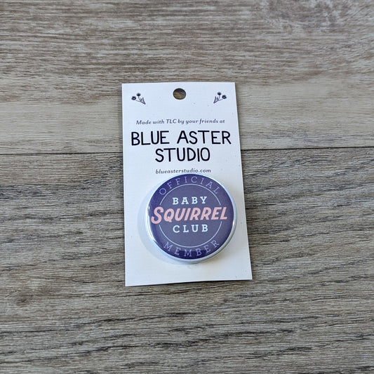 A 1.5 inch button with the words "Official Baby Squirrel Club Member" on it.
