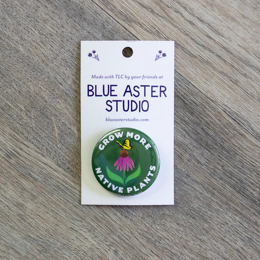 A 1.5 inch green pinback button that features an illustration of a coneflower with a swallowtail butterfly landing on it. The button has the words Grow More Native Plants printed in white around the illustration.