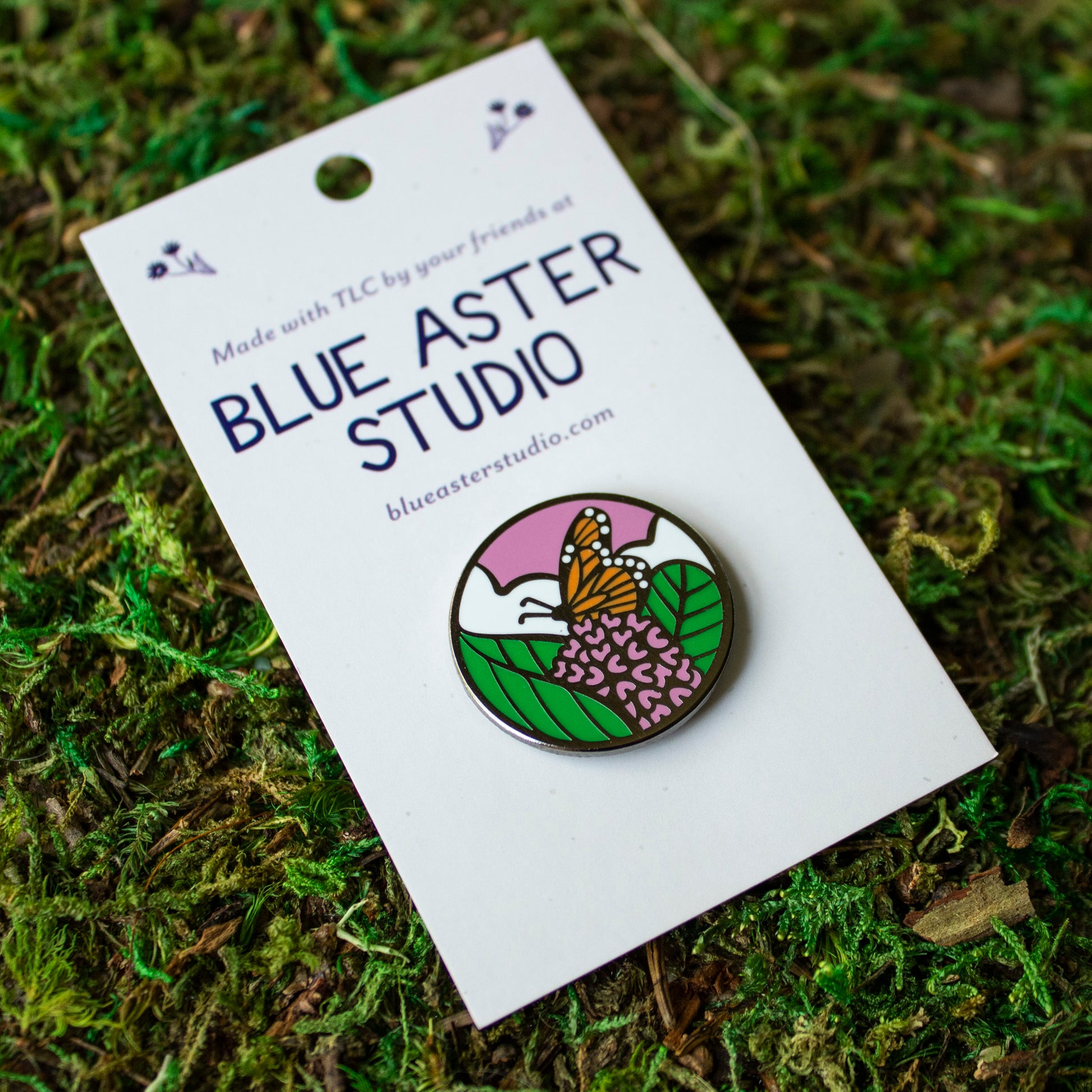 A monarch butterfly enamel pin.