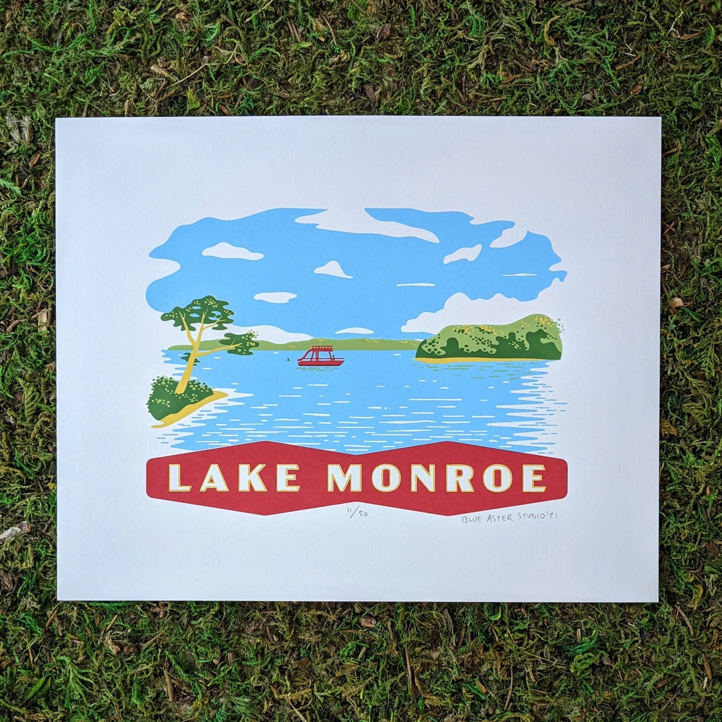 A scene on Lake Monroe that shows a pontoon boat and some swimmers surrouned by the treen lined shore of the Southern Indiana lake. At the bottom is a banner that reads "Lake Monroe." The screen print is inspired by vintage postcard art.