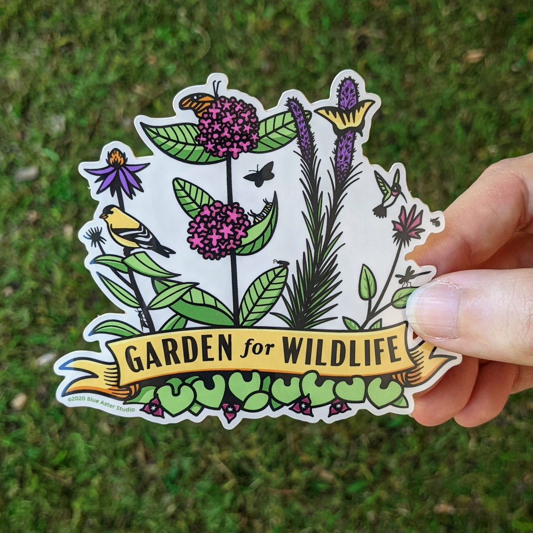 Garden for Wildlife sticker featuring illustrations of native plants such as coneflower, milkweed, blazing star, and bee balm, visited by pollinators like hummingbirds, bees, butterflies, and a goldfinch.