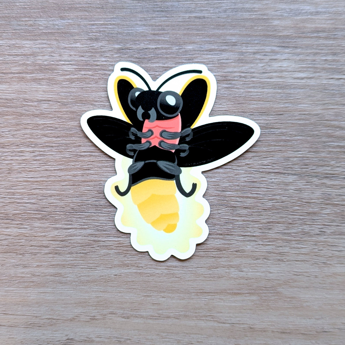 An illustrated sticker of a firefly in flights with a glowing abdomen