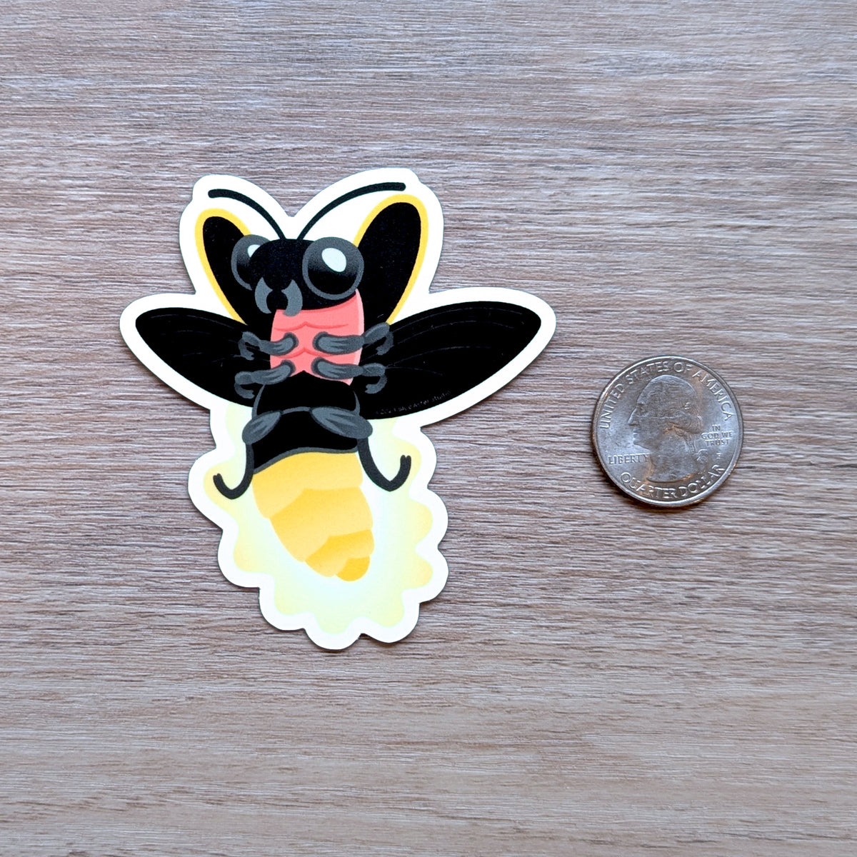 An illustrated sticker of a firefly in flights with a glowing abdomen with USD quarter to show scale