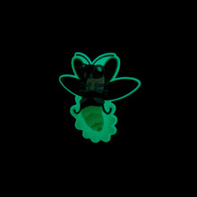 Load image into Gallery viewer, The lightning bug sticker glowing in the dark.
