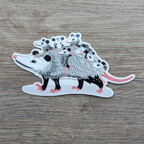 A vinyl sticker of an illustration of an opossum mom carrying her opossum babies on her back.