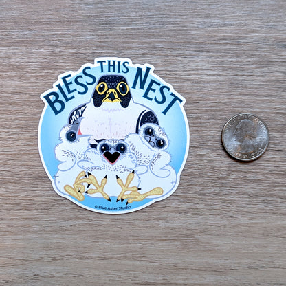 A round sticker depicting an illustrated parent peregrine falcon with three chicks with a USD quarter coin for scale