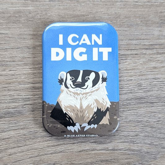A rounded rectangle magnet featuring an illustration of a badger emerging from a hole in the ground with the text I Can Dig It above its head.