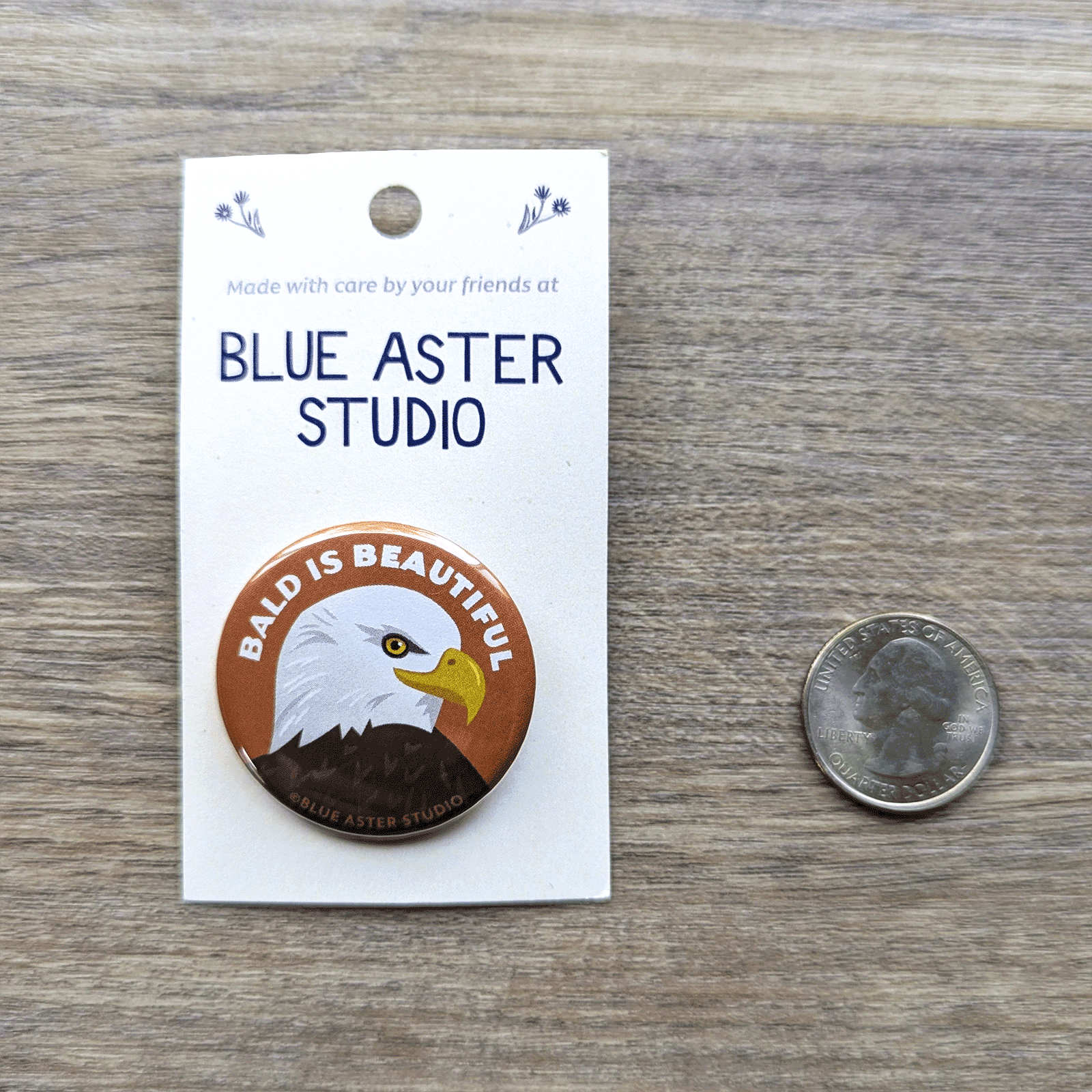 The bald eagle button with a USD quarter for scale