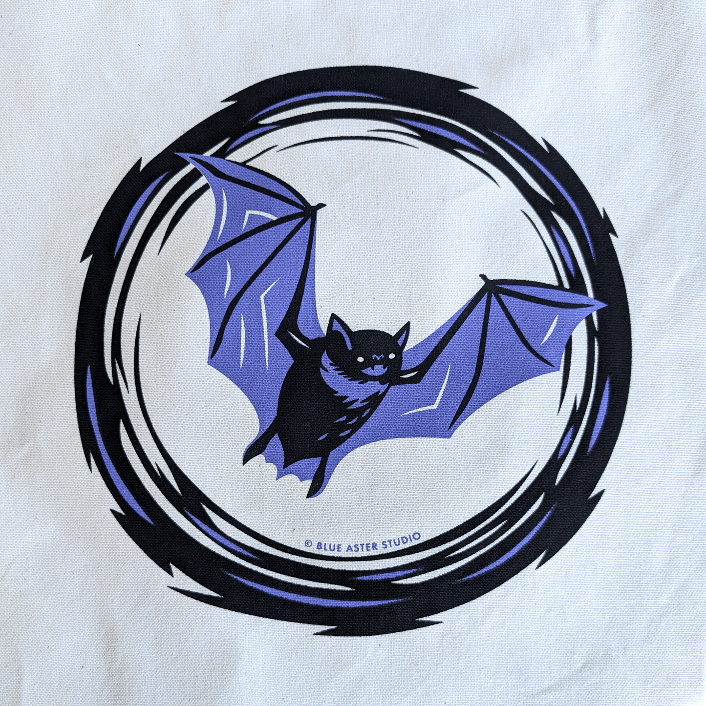 A close up of the flying bat screen printed design showing more detail.