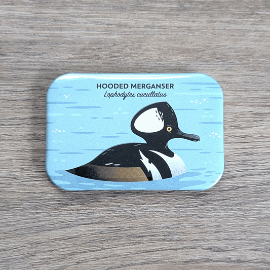 A rectangular magnet with rounded corners illustrated with a black, white, and brown duck with a large black and white crest.