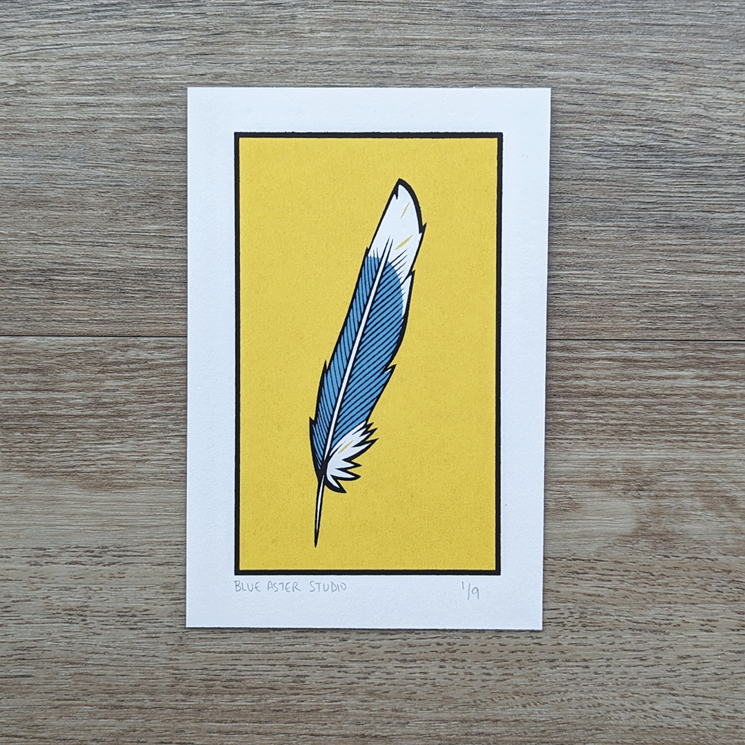 An original screen print of an illustration of a blue jay feather against a yellow background.