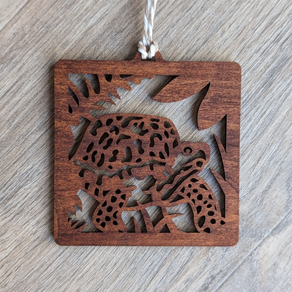 A brown wooden laser cut ornament of a box turtle.