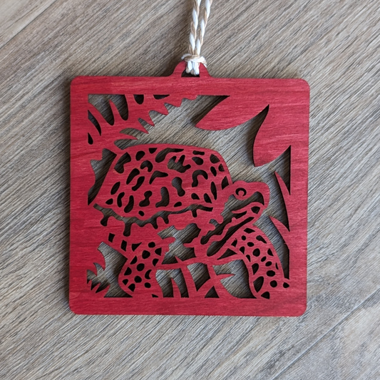 A red wooden laser cut ornament of a box turtle.