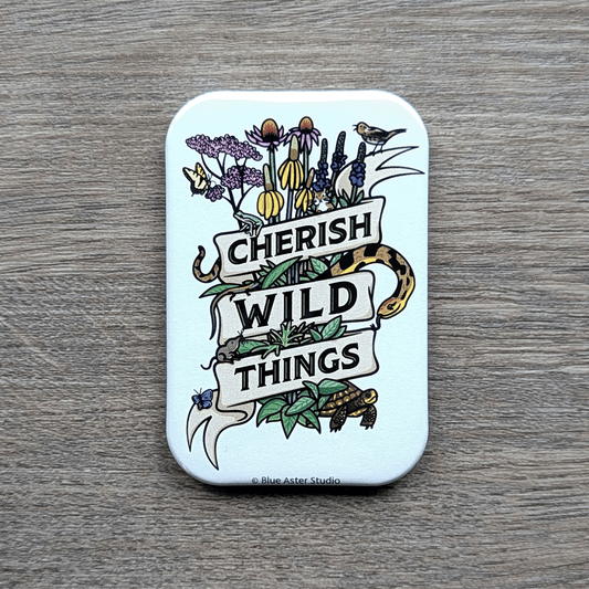 A 2 inch by 3 inch refrigerator magnet featuring an illustration of American prairie flora and fauna wrapped in a ribbon that reads Cherish Wild Things.