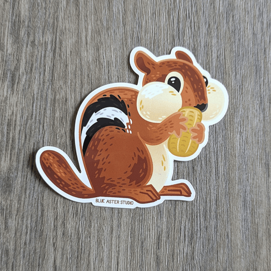 Sticker of an illustrated chipmunk holding a peanut.