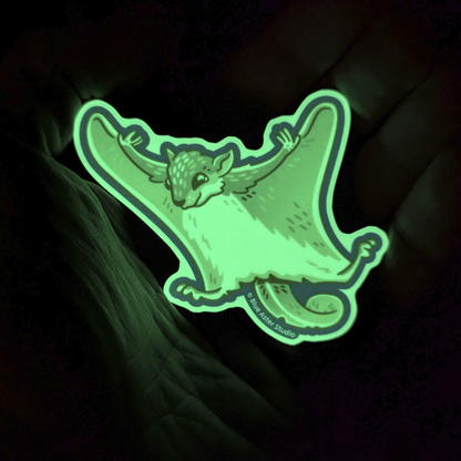 The flying squirrel sticker glowing bright green in the darkness.