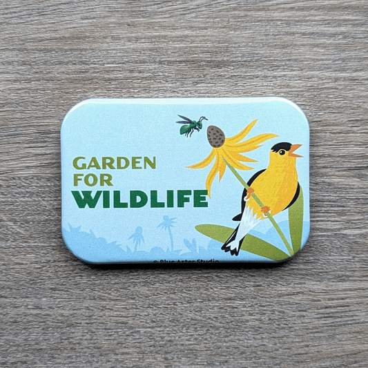 A 2 inch by 3 inch refrigerator magnet that featurs an illustration of a goldfinch perched on a brown eyed susan with a bee buzzing above with the words Garden For Wildlife next to it.