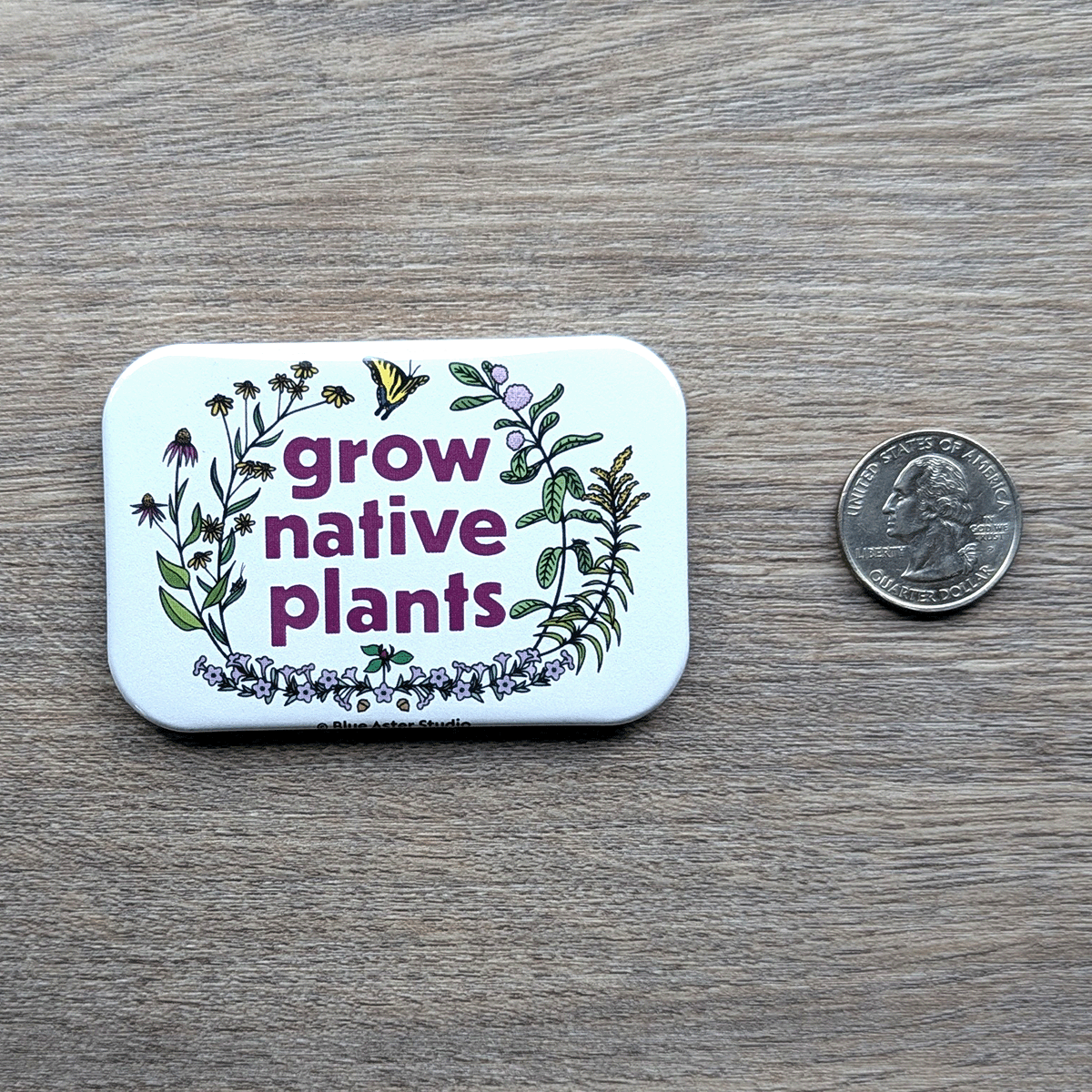 The Grow Native Plants magnet sitting next to a USD quarter to show scale.