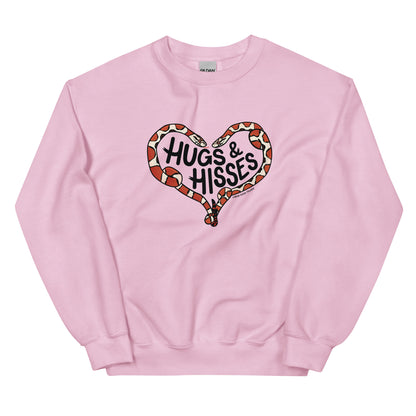 A pink sweatshirt with a pair of illustrated corn snakes forming a heart around the text "Hugs and Hisses"