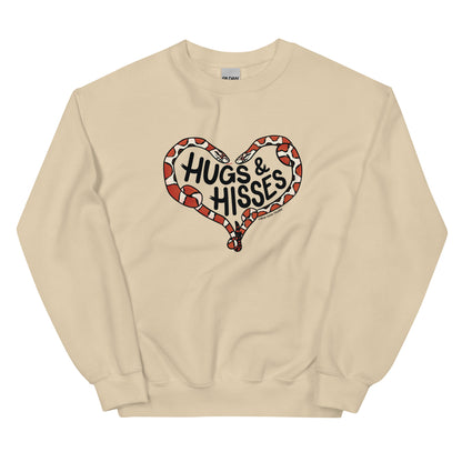 A tan sweatshirt with a pair of illustrated corn snakes forming a heart around the text "Hugs and Hisses"
