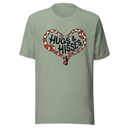 A sage green t-shirt with a pair of illustrated corn snakes forming a heart around the text "Hugs and Hisses"