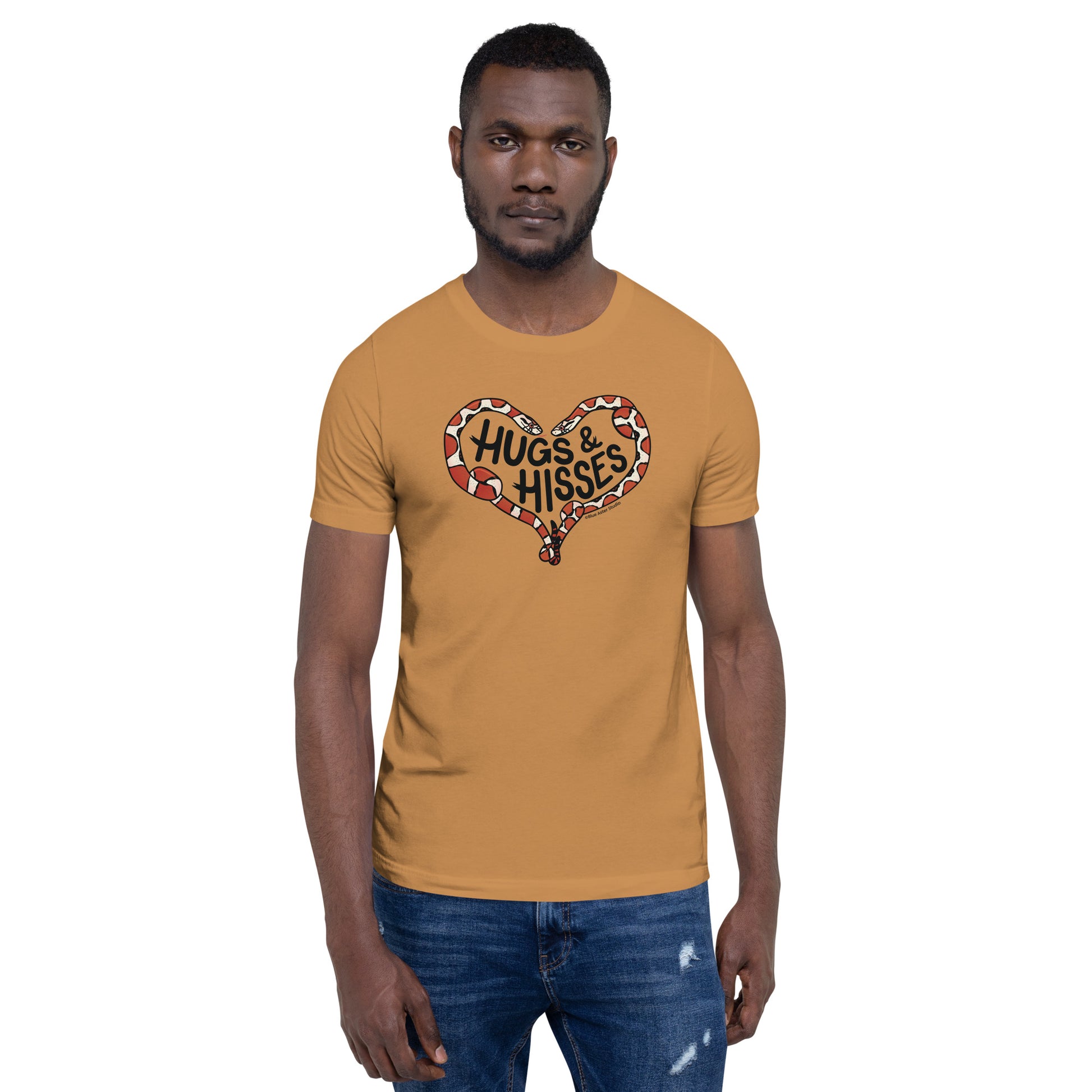 A male model wearing a toast colored t-shirt with a pair of illustrated corn snakes forming a heart around the text "Hugs and Hisses"