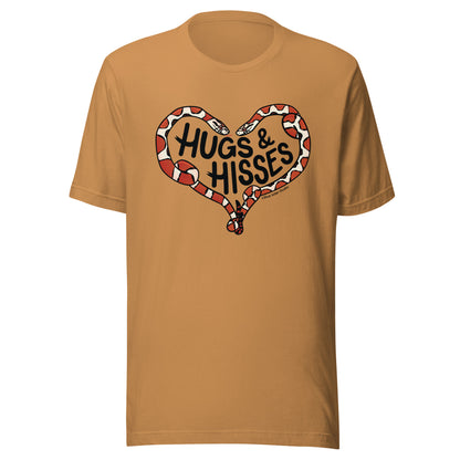 A toast colored green t-shirt with a pair of illustrated corn snakes forming a heart around the text "Hugs and Hisses"