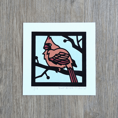A mini screen print of a female cardinal in four colors.
