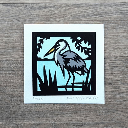 A screen printed illustration of a great blue heron.