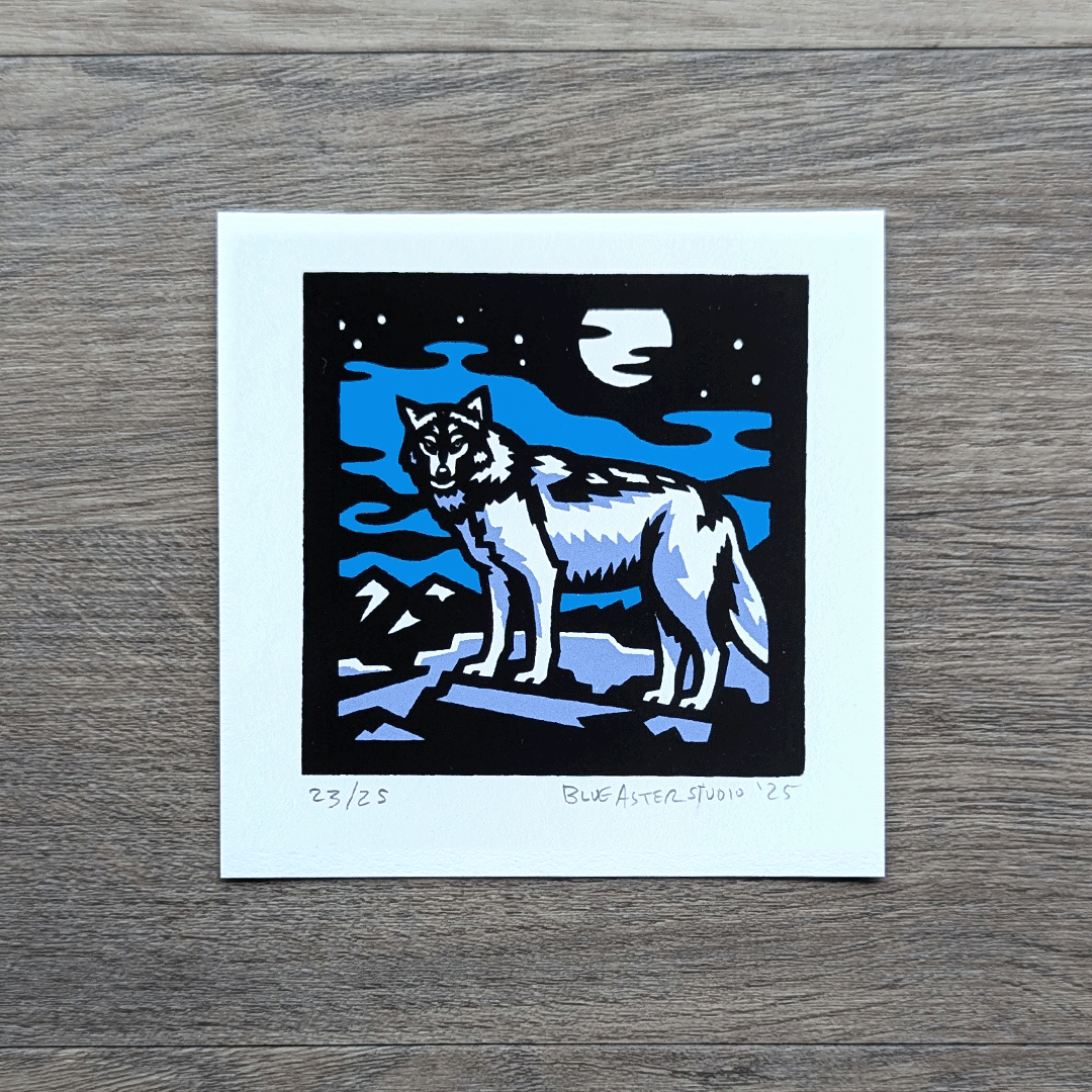 A square screen printed artwork of a gray wolf standing on a flat rock with mountains in the distance. A full moon shines above.