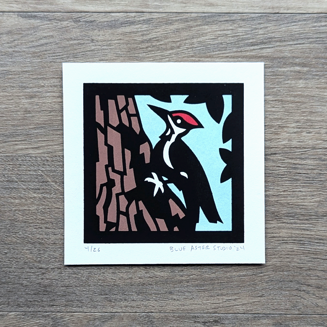 A screen printed image of a woodpecker climbing a tree