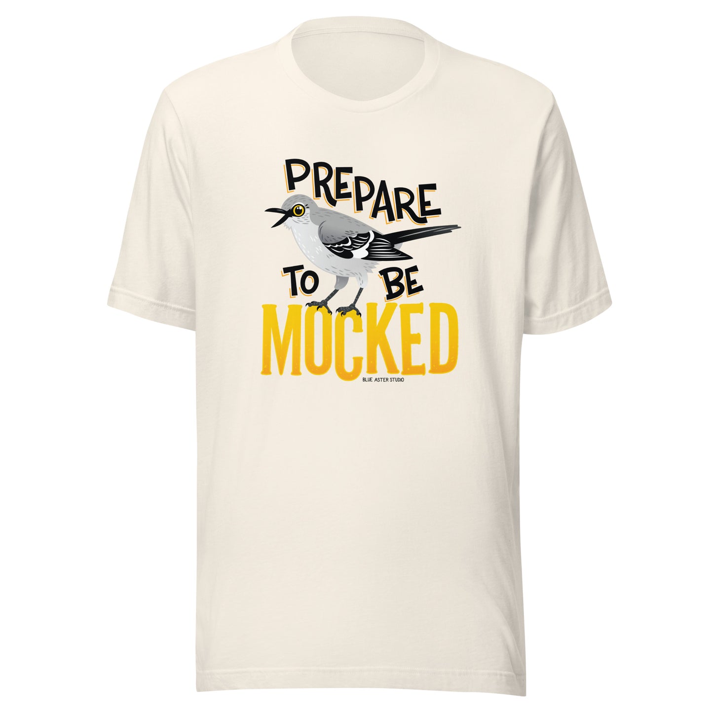 A creme tee shirt with the text "prepare to be mocked" with an illustrated mockingbird perched within it