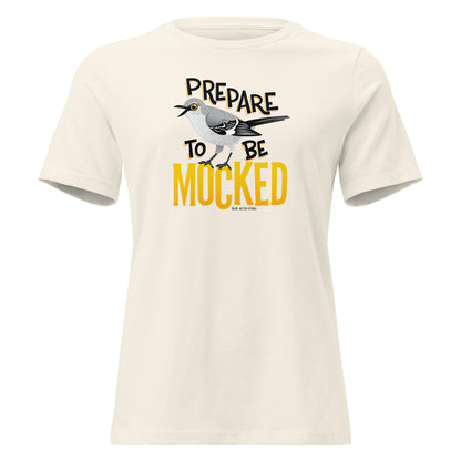 A creme women's cut tee shirt with the text "prepare to be mocked" with an illustrated mockingbird perched within it