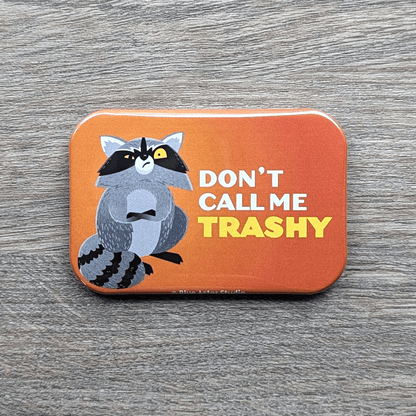 A 2 inch by 3 inch refrigerator magnet featuring an illustration of an upset raccoon with the words Don't Call Me Trashy.