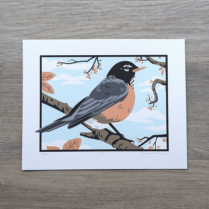 An original screen print of an illustration of an American robin sitting in a tree.