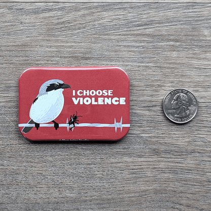 The shrike refrigerator magnet sitting next to a USD quarter for scale.