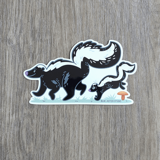 Sticker of an illustration of mama skunk with a baby skunk following behind.