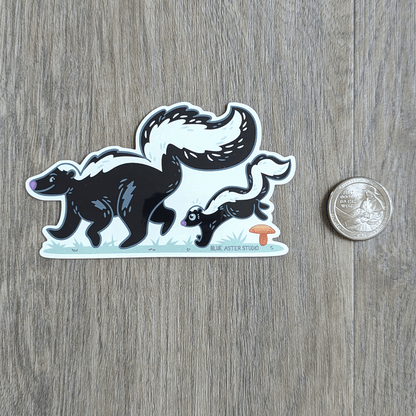 Skunks sticker sitting next to USD quarter to show scale.