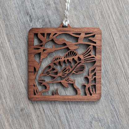 A square brown wooden ornament of a smallmouth bass.