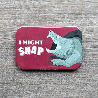 A 2x3 refrigerator magnet which features an illustration of a snapping turtle and the words I Might Snap.